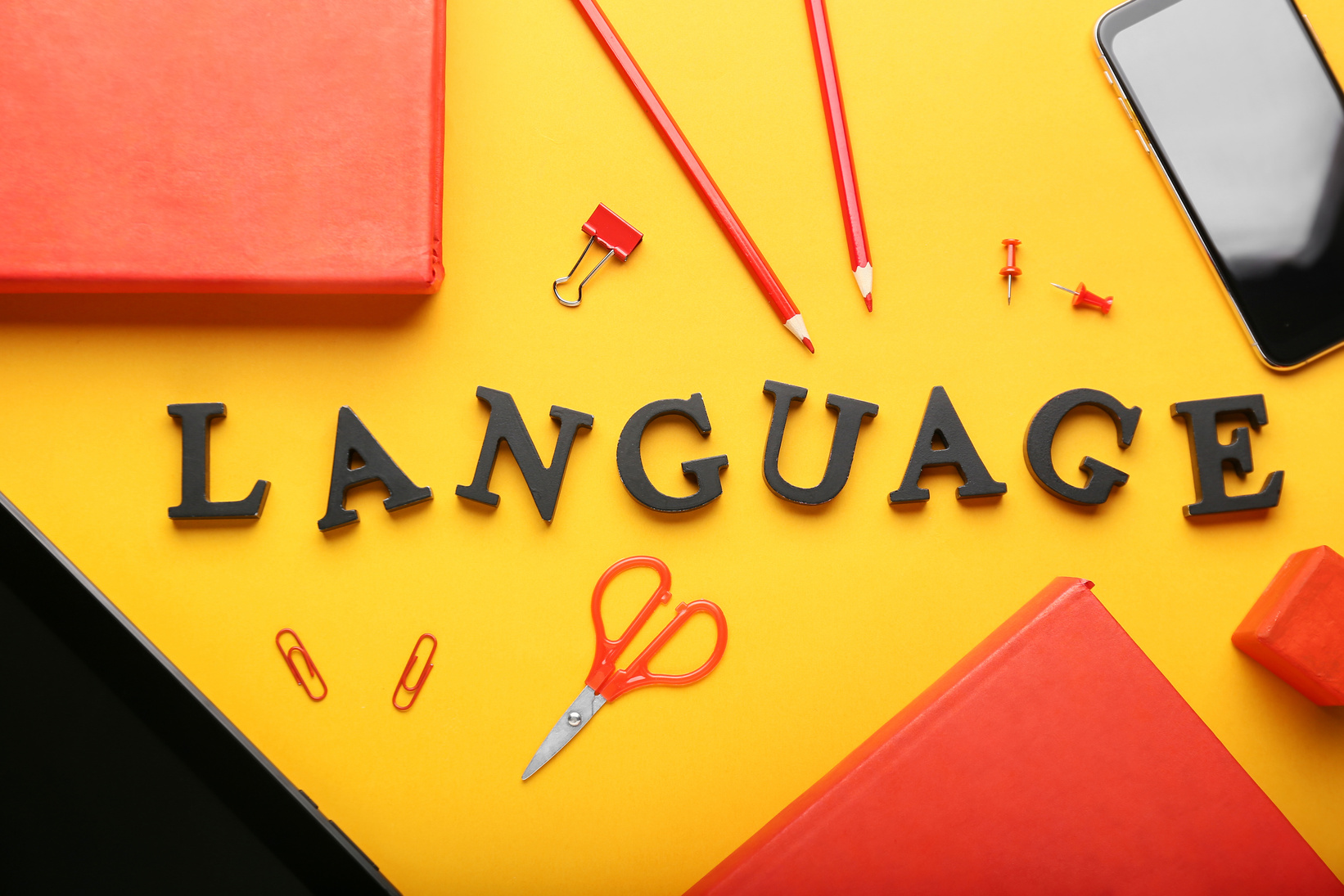 Stationery and Text LANGUAGE on Yellow Background