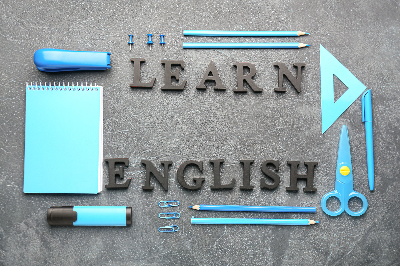 Stationery and Text LEARN ENGLISH on Grey Background